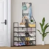 entryway-shoe-rack_1 Black entryway shoe rack beside a front door holding shoes, a hat and a bag