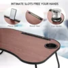 close-up of the built-in phone slot, pencil slot, and cup holder