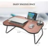 lap desk with a tablet, laptop, mouse, and glass showing tabletop dimensions