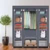portable-closet-organizer-wardrobe_1 Gray portable closet organizer in a bedroom holding hanging clothes and folded stacks
