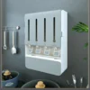 wall-mounted-seasoning-box_6 Grey seasoning organizer on a kitchen wall above pans and cutlery